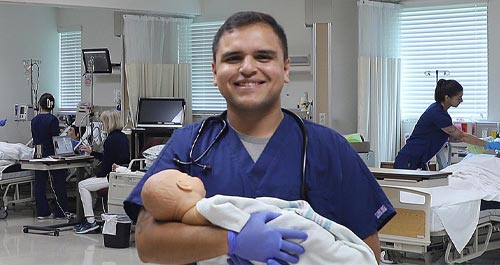 Nursing Student holding manikin baby