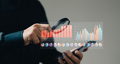 Chart analysis by person in suit with phone