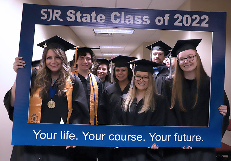 SJR State students with graduation frame
