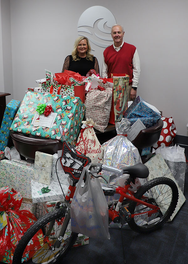 SJR State President Joe Pickens, Project PRAISE site coordinator Kara McKinley with gifts from Project PRAISE